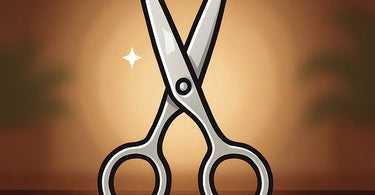 A close-up image of a professional hairstylist's hands holding sharp shears, poised to cut a section of hair in a modern salon.
