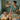 A massage therapist smiling while a client sleeps peacefully and snores lightly on a comfortable massage table in a serene spa setting