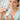 Close-up of a professional aesthetician's hands opening a luxury skincare jar, capturing the moment of the seal breaking