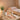 Professional esthetician performing full body wax treatment in spa setting