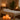 Himalayan salt stones arranged on massage table with spa towels and essential oils