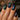 Close-up of stunning magnetic nail art design showing cat-eye effect with blue and silver gel polish