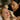 Nail technician performing waxing service on client's brows during manicure appointment