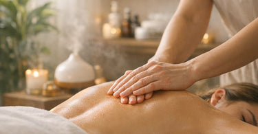 A spa professional performing a therapeutic hand massage on a client in a serene, calm treatment room