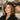 A hairstylist providing a volume-boosting blowout and consult to a client with fine or thinning hair in a modern salon setting