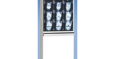 The Trimline Basic Illuminator 1 over 1 (2 Bulb) by Wolf X-Ray mounted on a white wall featuring a large bright white viewing surface ideal for skin analysis and waxing precision in a professional spa setting.