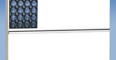 The Trimline Plus Illuminator / 4 over 4 (4 Bulb) by Wolf X-Ray mounted on a wall displaying a skin analysis chart with bright even lighting