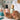 A professional nail technician holds a bottle of premium gel nail polish, symbolizing the shift towards non-toxic and certified nail products in the salon.