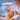 A professional esthetician performing an LED light therapy facial treatment on a client in a serene spa setting.