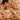 A spa professional consults with a client, gently pointing to the ear and hand, highlighting attention to detail for unexpected grooming and wellness areas.