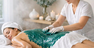 A relaxing spa treatment showing a client comfortably wrapped in a marine algae body wrap, with warm towels and a serene atmosphere.