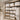 A beautifully organized spa linen closet with neatly stacked white towels on shelves, baskets of supplies, and spa products, representing efficiency and order.