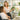 Aesthetician consulting with a client about clean, sulfate-free and paraben-free skincare products in a modern spa setting