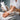 Close-up of a professional applying urea cream to a client's dry heel during a spa pedicure treatment