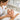 A spa professional performs a gentle lymphatic facial massage on a relaxed client to reduce puffiness and sculpt facial contours.