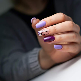 Trendy purple nail designs with gradient, metallic, and floral accents.