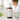 Close-up of a professional spa aesthetician analyzing the INCI ingredient label on a skincare serum bottle in a modern treatment room