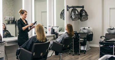 Modern salon equipment setup featuring facial steamers, massage tables, and waxing supplies