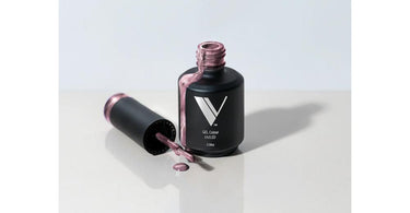 V Beauty Pure V Gel Polish bottle in shade #182, a sheer nude color, shown with a professional brush stroke on a nail swatch.