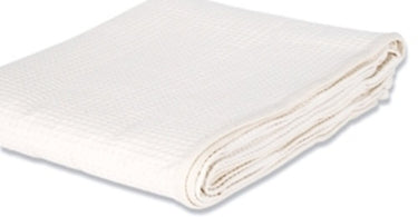 Natural colored waffle weave spa blanket folded neatly, showcasing its textured weave and professional quality.