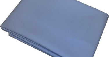 Light Blue Wax Pad by Amber Products on a table, protecting the surface from wax drips and spills in a professional spa setting.
