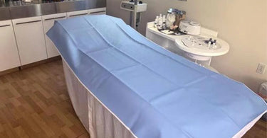 Wax pad protecting a spa treatment table from wax spills