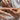 Close-up of a hand applying cuticle oil to nails