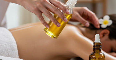 Professional massage therapist using high-quality massage oil during a spa treatment