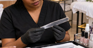 Professional nail file and manicure tools at a nail technician workstation illustrating when a worn nail file should be replaced during salon services
