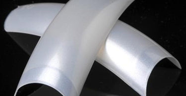 Close-up of Lamour White Pearl French Nail Tips showing pearlescent sheen and professional packaging