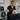 A professional black airbrush makeup hose neatly coiled and stored on a modern metal hanger, showcasing the importance of proper storage for salon efficiency, featuring a clean and organized beauty workspace.