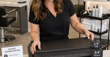 A woman standing comfortably on a thick, ergonomic anti-fatigue mat in a modern spa or salon setting, highlighting proper thickness for staff wellness.