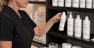 A close-up view of well-organized professional back bar bottles with clear, easy-to-read labels, featuring Pure Spa Direct wholesale products.