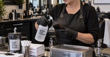 Professional beard brush and comb set on a clean barber station with disinfectant jar and sanitation supplies for barber shop hygiene