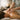 A massage therapist's hands applying targeted pressure to a client's shoulder to release a muscle knot