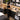 Professional salon backbar being organized with supplies removed from cardboard shipping boxes and placed into clean permanent storage