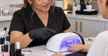 Professional nail salon gel manicure service with a client curing her nails under a nail lamp