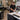 Salon professional wiping down a wax station with professional cleaners, with wax warmers and spatulas neatly organized for closing duties