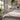 Clean professional spa treatment room with a massage table, folded towels, skincare supplies, and a welcoming atmosphere illustrating the causes of overnight treatment room odors