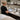 A diverse team of spa and salon professionals collaborating around a shared treatment station, representing the importance of clear equipment-sharing schedules for a harmonious workplace.