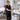Stack of clean terry cloth facial headbands in various colors arranged on a spa treatment table, ready for the next client service