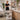 An organized, clean spa treatment room with neatly arranged supplies on shelves and a cart, avoiding clutter on the floor.