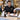 Professional spa and salon front desk staff discussing service options in a modern reception area