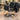 Professional salon styling chair with a hydraulic pedestal base and loose haircut clippings collecting around the bottom on the salon floor