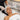 Woman receiving a spa facial treatment with her hair carefully protected by a towel to prevent damage from products and steam.