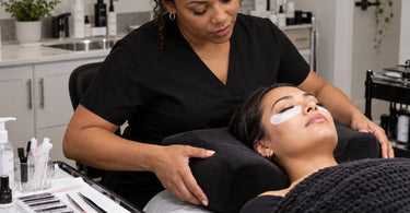 Professional lash treatment pillow positioned on a spa treatment bed, illustrating pillow stability and client head support during eyelash extension services