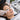 Professional lash extension appointment demonstrating under-eye lash tape placement and lower lash isolation during a beauty salon treatment