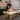An illustration showing a massage therapist's body mechanics, highlighting shoulder position, stance, and leverage affected by the width of the massage table.