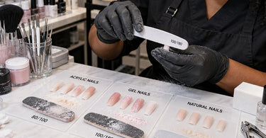 Professional nail files and buffers used for shaping acrylic, gel, and natural nails at a salon manicure station