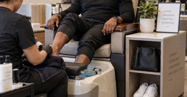 A modern pedicure station with ample storage for client shoes and bags, showcasing an organized and luxurious spa environment.